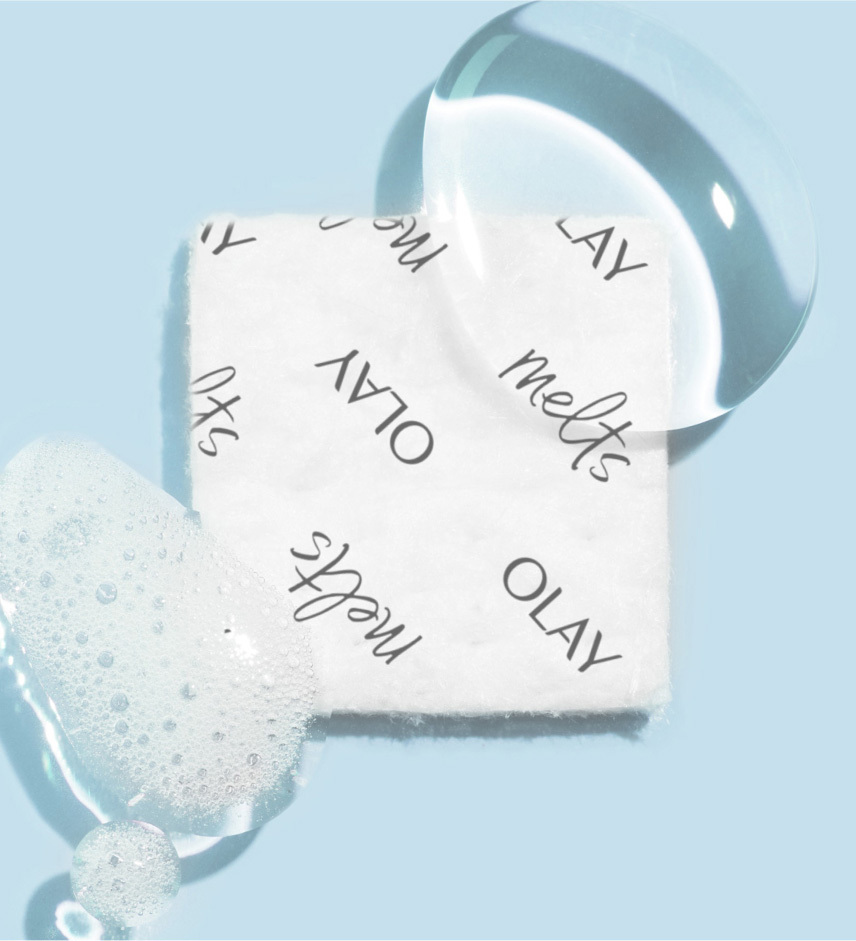 Olay Cleansing Melts square with bubbly foam over its bottom left corner and a water droplet over its top right corner