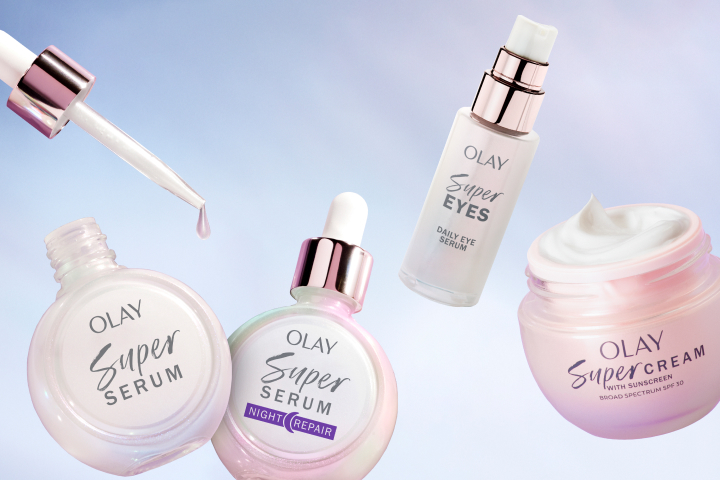 Four Olay Super Collection products floating in front of an airy blue pink background